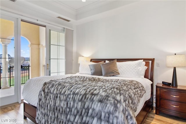21 Via Visione Unit 201, Henderson, NV 89011 - bedroom with access to outside, light wood-type flooring, and crown molding