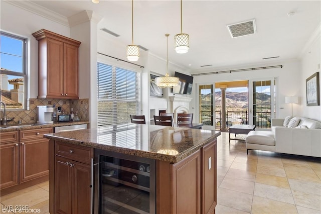 21 Via Visione Unit 201, Henderson, NV 89011 - kitchen with beverage cooler, open floor plan, a sink, decorative backsplash, and crown molding