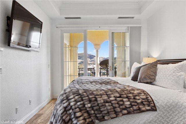 21 Via Visione Unit 201, Henderson, NV 89011 - bedroom featuring wood finished floors, access to outside, a tray ceiling, and baseboards