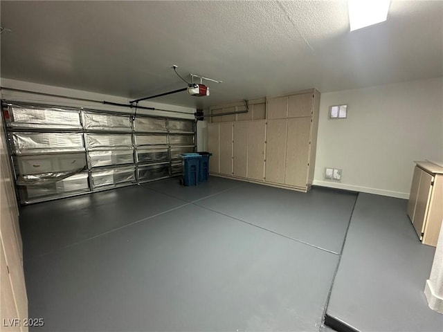 garage featuring baseboards and a garage door opener