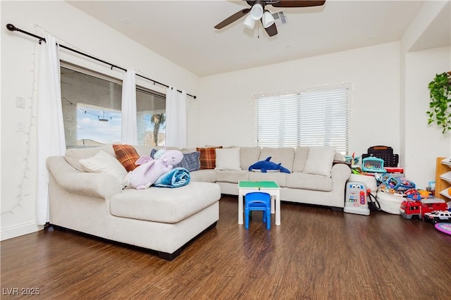 living area featuring plenty of natural light, visible vents, and wood finished floors