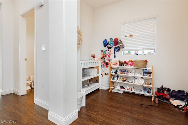 bedroom featuring baseboards and wood finished floors