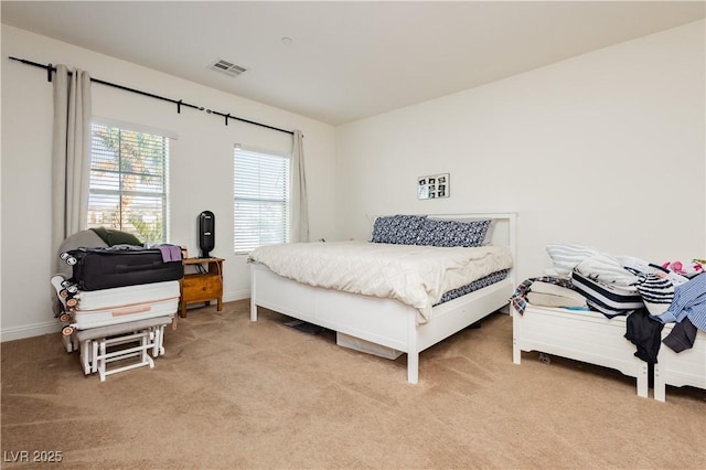 bedroom featuring light colored carpet, visible vents, and baseboards