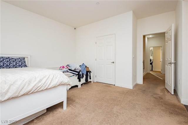 bedroom featuring baseboards and carpet