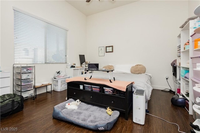 bedroom featuring baseboards and wood finished floors