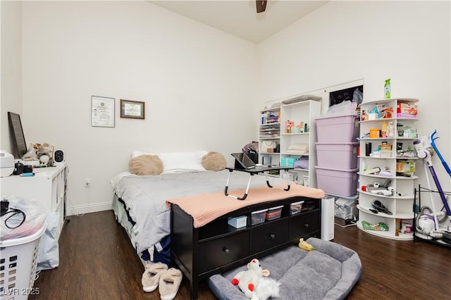 bedroom featuring wood finished floors, baseboards, and ceiling fan