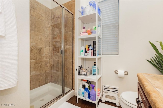 full bath featuring toilet and a stall shower