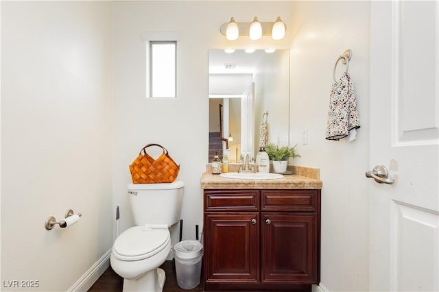 bathroom featuring vanity, toilet, baseboards, and visible vents