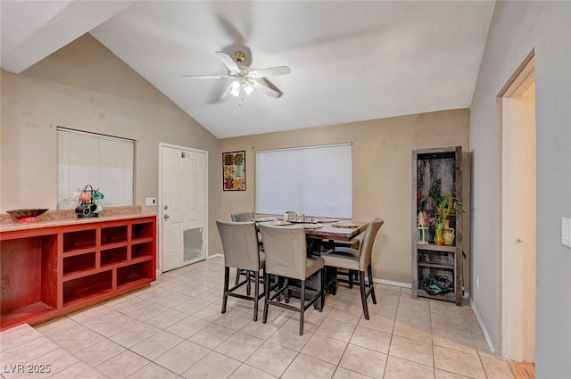 dining area with lofted ceiling, ceiling fan, light tile patterned floors, and baseboards