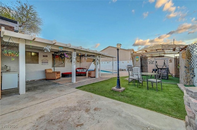 view of yard with a patio area, fence, and a fenced in pool