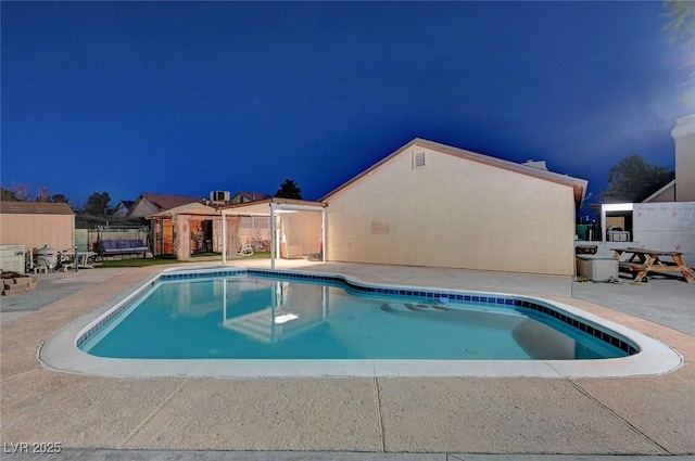 view of swimming pool with a patio, fence, and a fenced in pool