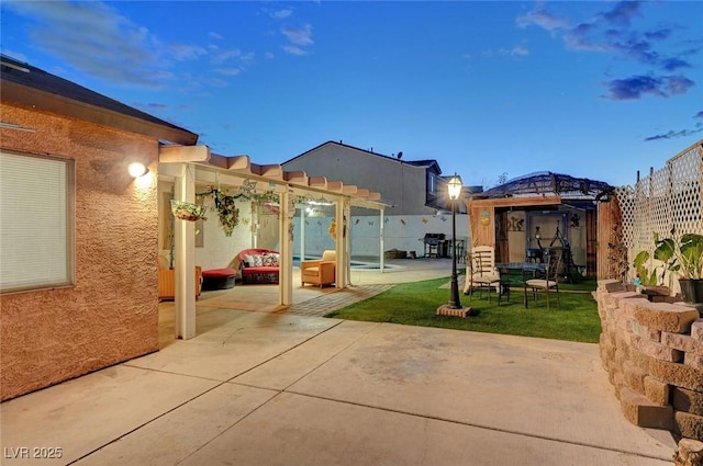 view of patio featuring a gazebo, fence, and a pergola