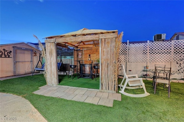 view of yard with a storage shed, fence, and an outdoor structure