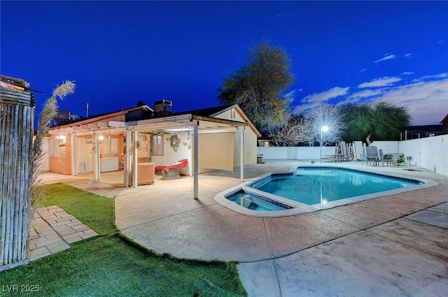 pool at twilight featuring a fenced in pool, a patio area, and a fenced backyard