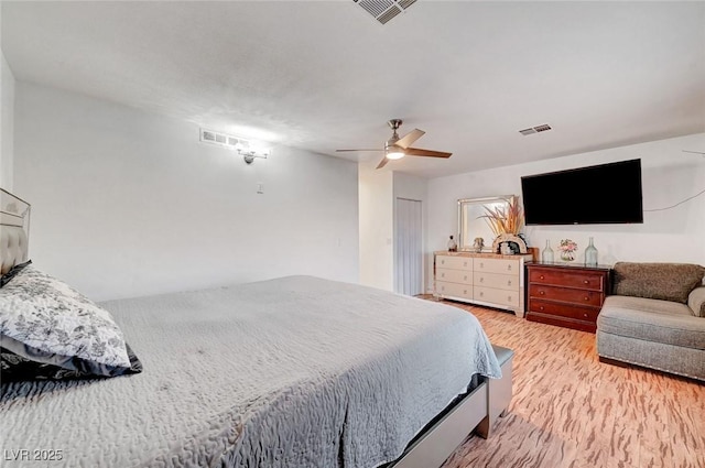 bedroom featuring ceiling fan, visible vents, and light wood-style floors