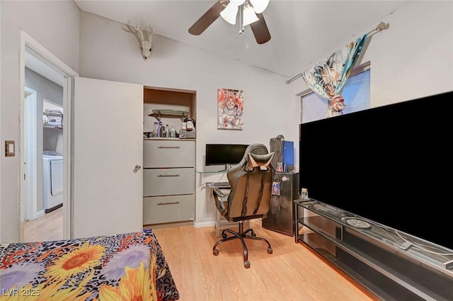 bedroom featuring a ceiling fan, washer / clothes dryer, and wood finished floors