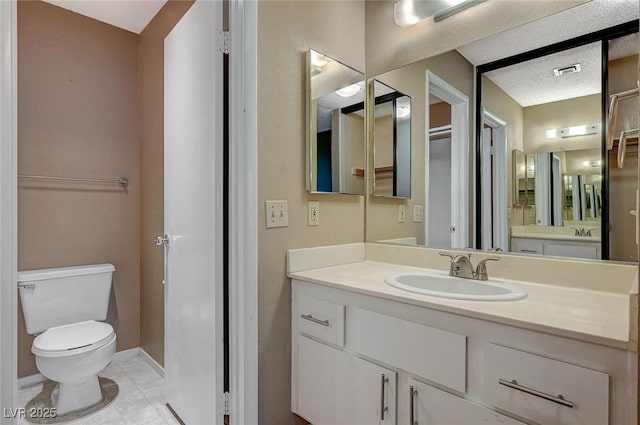 bathroom with tile patterned flooring, toilet, visible vents, vanity, and baseboards