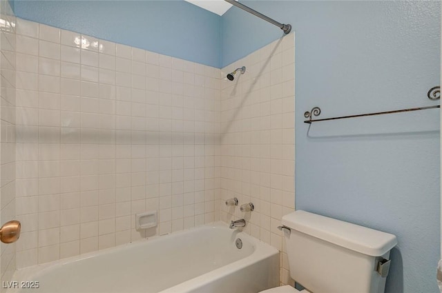 bathroom featuring bathing tub / shower combination and toilet