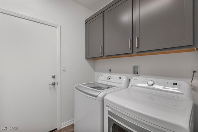 washroom featuring cabinet space and independent washer and dryer