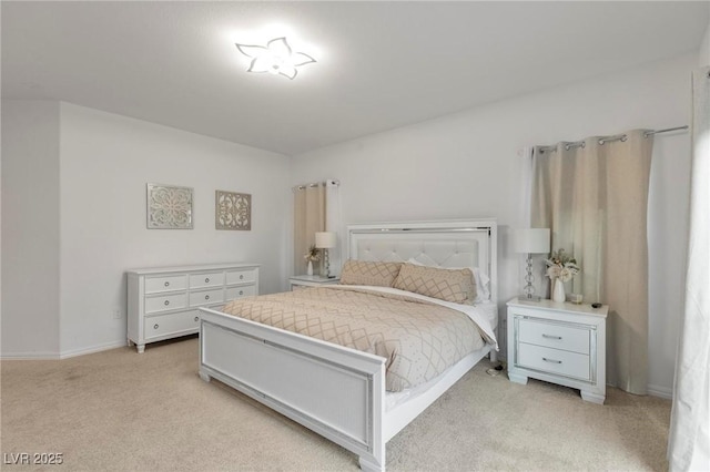 bedroom featuring baseboards and light colored carpet