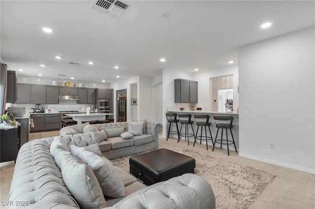 living area with visible vents and recessed lighting