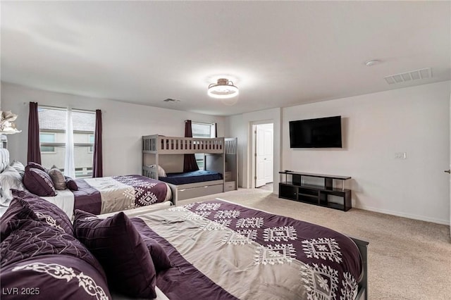 carpeted bedroom featuring visible vents and baseboards