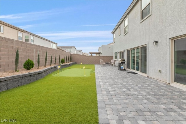 view of yard with a fenced backyard and a patio