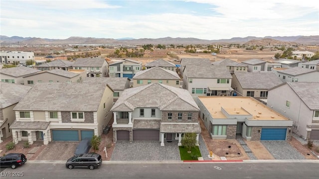 drone / aerial view featuring a residential view and a mountain view