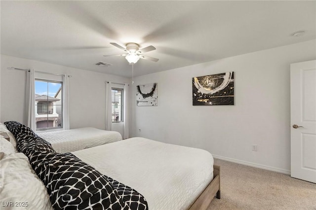 bedroom with visible vents, light carpet, baseboards, and multiple windows