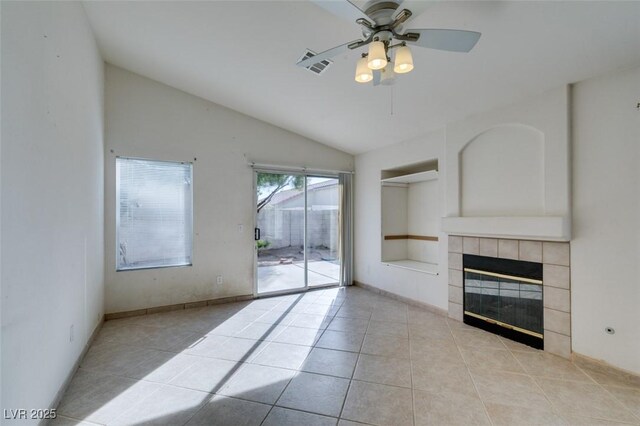 unfurnished living room featuring light tile patterned floors, a fireplace, visible vents, a ceiling fan, and vaulted ceiling