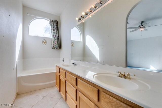full bath with double vanity, a garden tub, a sink, and tile patterned floors