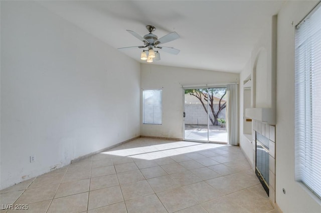 unfurnished living room featuring vaulted ceiling, light tile patterned flooring, and a ceiling fan