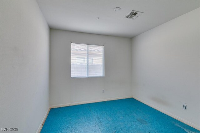 empty room featuring carpet, visible vents, and baseboards