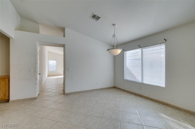 spare room with light tile patterned floors, lofted ceiling, visible vents, and baseboards