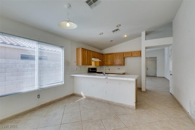kitchen featuring under cabinet range hood, a peninsula, visible vents, light countertops, and stainless steel electric range oven