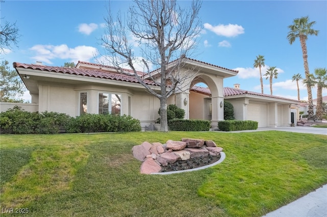 mediterranean / spanish-style home featuring concrete driveway, a tiled roof, an attached garage, a front yard, and stucco siding