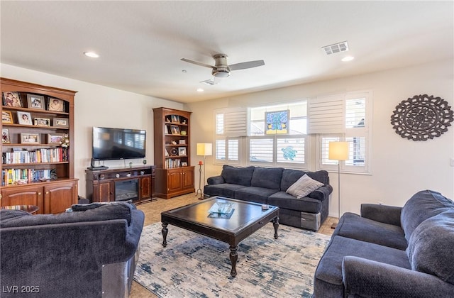 living room featuring visible vents, a ceiling fan, and recessed lighting