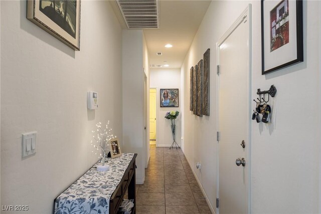 corridor with baseboards, tile patterned flooring, visible vents, and recessed lighting