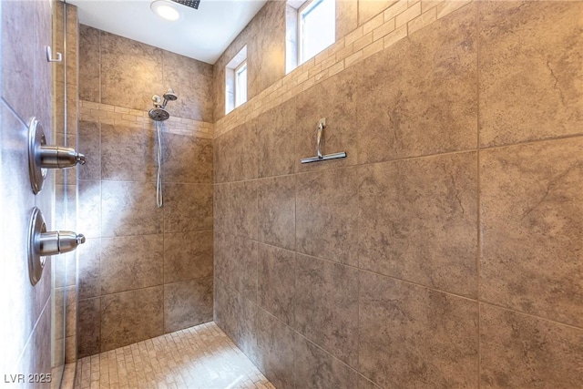 interior details featuring tiled shower