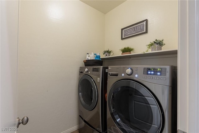 laundry area with laundry area, baseboards, and washing machine and clothes dryer