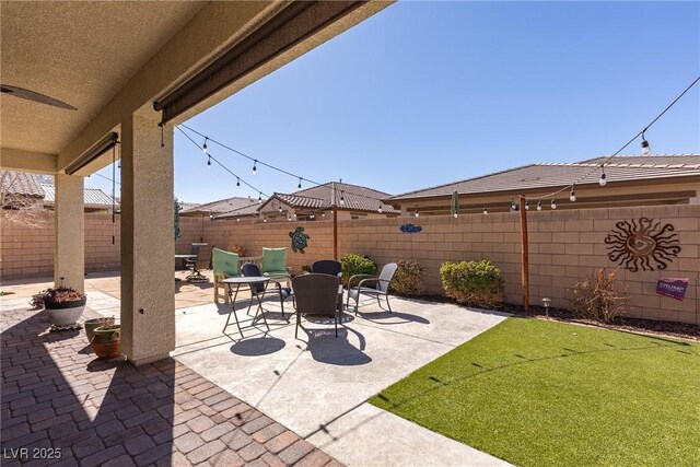 view of patio / terrace featuring ceiling fan and a fenced backyard