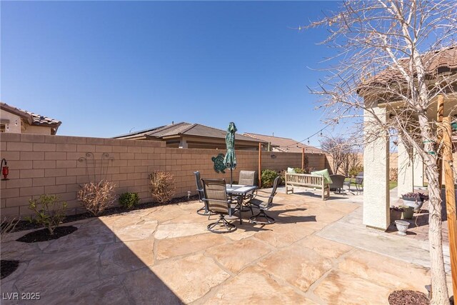 view of patio / terrace featuring outdoor dining space and a fenced backyard