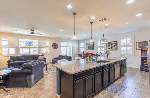 kitchen featuring visible vents, open floor plan, a sink, a kitchen island with sink, and stainless steel dishwasher