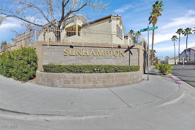 community / neighborhood sign featuring fence