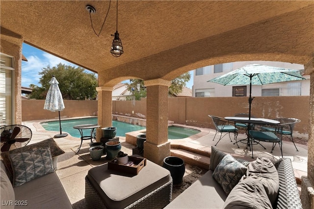 view of patio with a fenced in pool, a fenced backyard, and an in ground hot tub