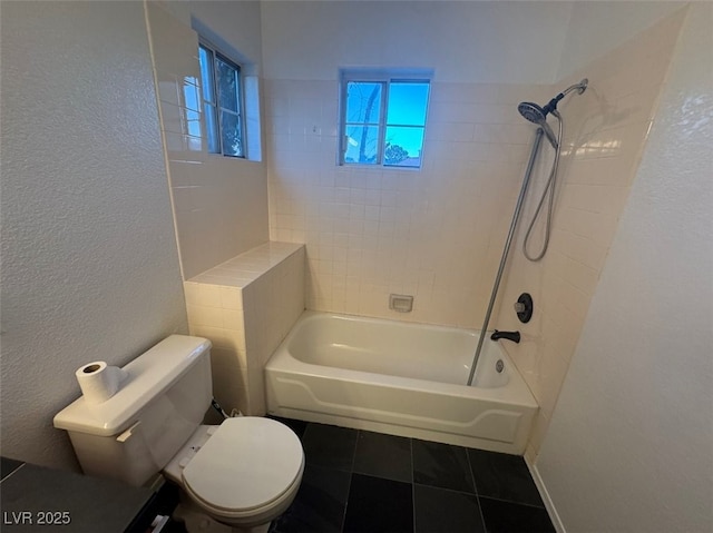 full bath with shower / washtub combination, tile patterned flooring, a textured wall, and toilet