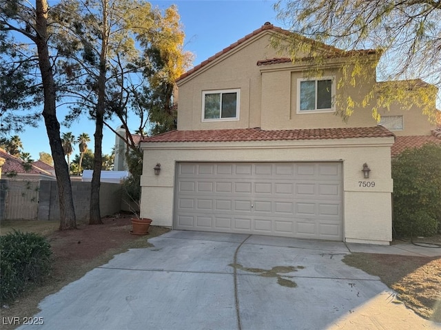 view of front of house featuring a tile roof, stucco siding, an attached garage, fence, and driveway