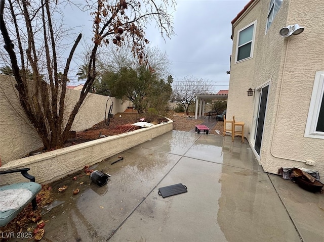 exterior space with a fenced backyard, a pergola, and a patio