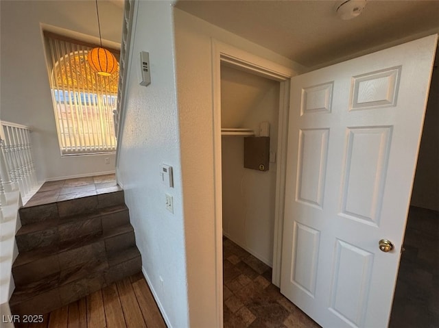 stairway featuring baseboards and wood finished floors