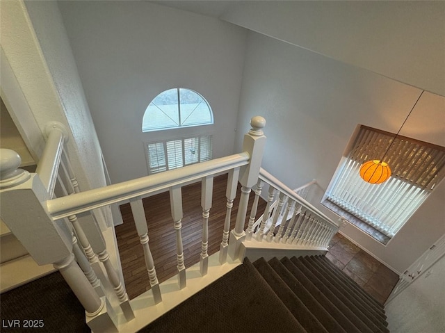 stairs featuring a towering ceiling